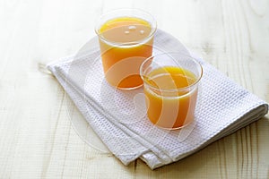 Glass of orange juice on a wooden table. Fresh orange juice