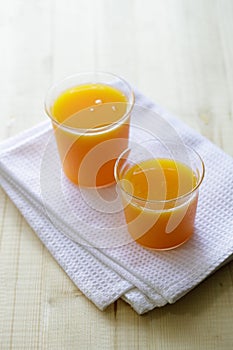 Glass of orange juice on a wooden table. Fresh orange juice