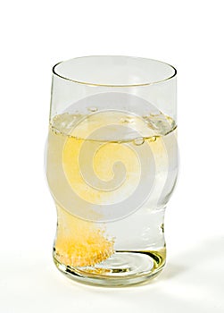 Glass with orange sparkling tablet