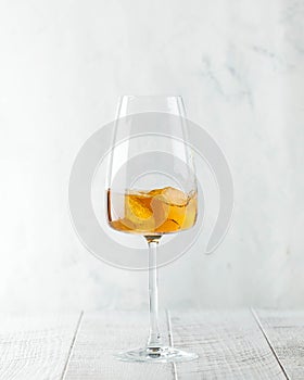 A glass of orange wine and ice. The concept of a winery, wine shop. Copy space