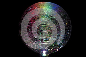 Glass orb breaking light down into a colourful spectrum