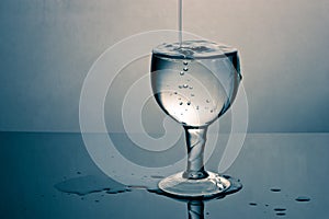 A glass overfilled with water