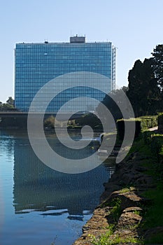 Glass palace reflected in artificial lake