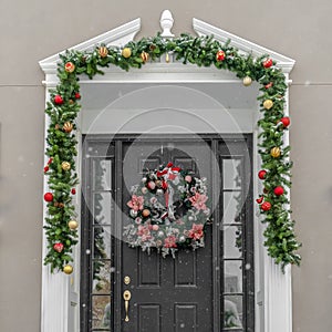 Glass paned front door with garland and wreath