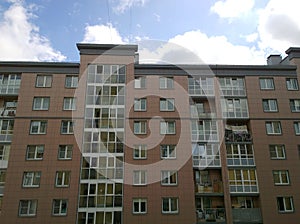 Glass and panel facade of a new multi-story residential building. Sale and rental of economy class apartments and comfortable hous