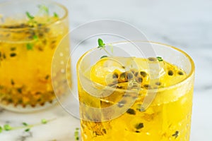 Glass of passion fruit juice on marble table