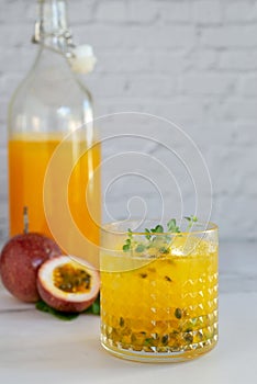 Glass of passion fruit juice on marble table