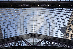 Glass pattern ceiling with buildings seen through. Skylight in train station