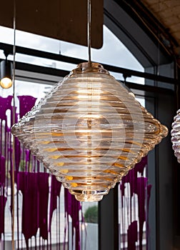 Glass pendant light at the Tom Dixon flagship store and showroom at Coal Drops Yard, Kings Cross, London UK