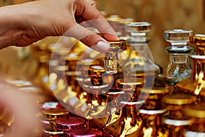 Glass perfume bottles based oils.A Bazaar, market. Macro. Gold and pink gamma