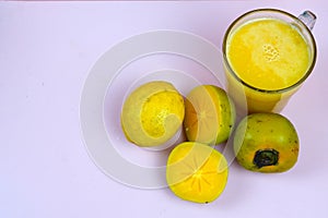 a glass of persimmon lemonade. Persimmon lemonade is a refreshing drink. photo
