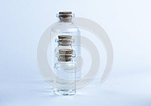 Glass pharmacy bottles with liquid on blue background