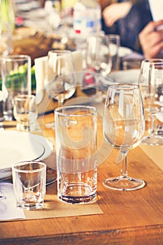 A glass, a pile, a glass for wine. Table setting.