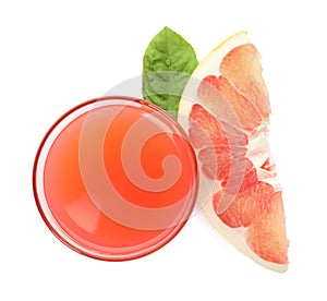 Glass of pink pomelo juice, fruit and green leaf isolated on white, top view