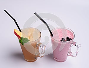 Glass of pink strawberry milkshake or cocktail isolated on white background