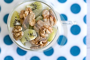 Glass with Plain yogurt with kiwi and nuts photo