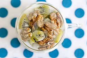 Glass with Plain yogurt with kiwi and nuts photo