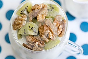 Glass with Plain yogurt with kiwi and nuts photo