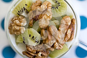 Glass with Plain yogurt with kiwi and nuts photo