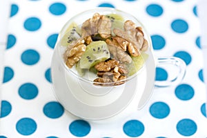 Glass with Plain yogurt with kiwi and nuts photo