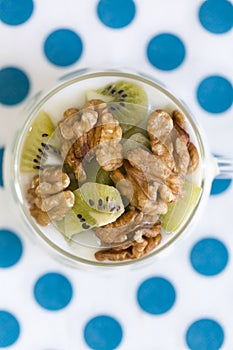 Glass with Plain yogurt with kiwi and nuts photo