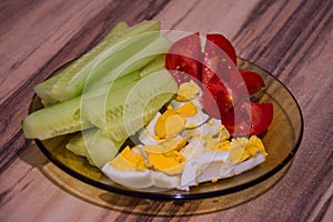 Glass plate with healthy food, full with tomatoes cucumbers and eggs