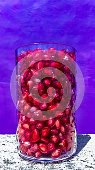 A glass of pomegranate granules..