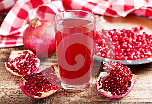 Glass of pomegranate juice with fresh fruits