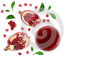 A glass of pomegranate juice with fresh pomegranate fruits decorated with leaves isolated on white background. Top view