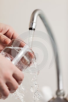 Glass pouring fresh drink water