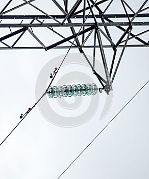 Glass prefabricated voltage insulators on poles high-voltage power lines. Electrical industry