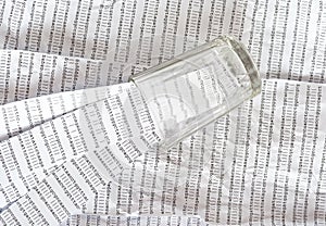 Glass on a printout of DNA sequence, stripes of DNA sequences inside