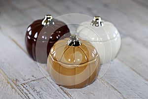 Glass Pumpkins against distressed wooden surface backbround