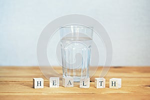 Glass of pure water with health word written in blocks