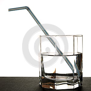 Glass of pure water with a straw for a cocktail