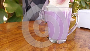 a glass of purple milk drink