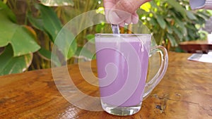 a glass of purple milk drink