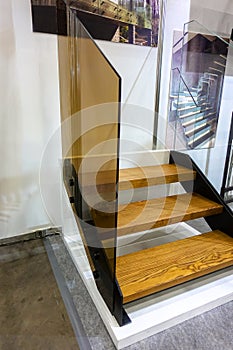 Glass railing of wooden staircase for indoor home