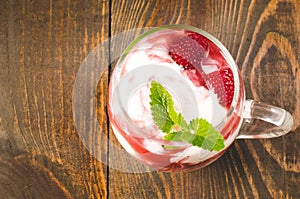 glass of raspberry smoothie with mint/glass of raspberry smoothie with mint on a wooden background. Healthy breakfast. Top view