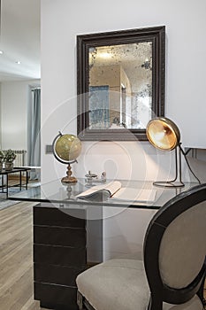 Glass reading table with vintage lamp and mirror in vacation