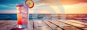 Glass with red aperol spritz cocktail on wooden table on beach near sea water at sunset. Summer vacation concept background.