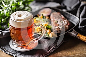 Glass of red beer in pub or restavurant on table with delicoius food