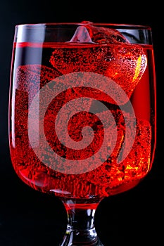 Glass of red drink with ice