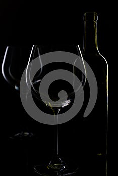 Glass of red and pink wine on a black background. Wine list menu. Close up of the power of glasses and bottles in low key