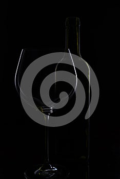 Glass of red and pink wine on a black background. Wine list menu. Close up of the power of glasses and bottles in low key