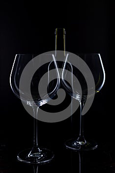 Glass of red and pink wine on a black background. Wine list menu. Close up of the power of glasses and bottles in low key