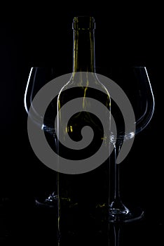 Glass of red and pink wine on a black background. Wine list menu. Close up of the power of glasses and bottles in low key