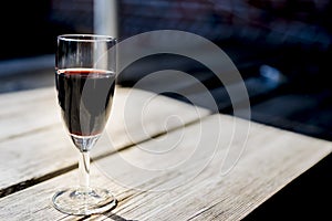 Glass of red port, on wooden table