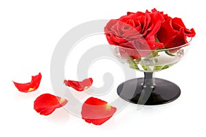 Glass with red roses and red leaves