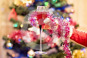 A glass of Red sparkling wine in a female hand